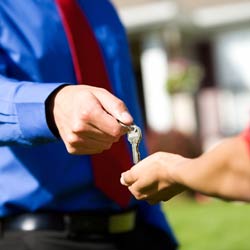 man handing home owner keys