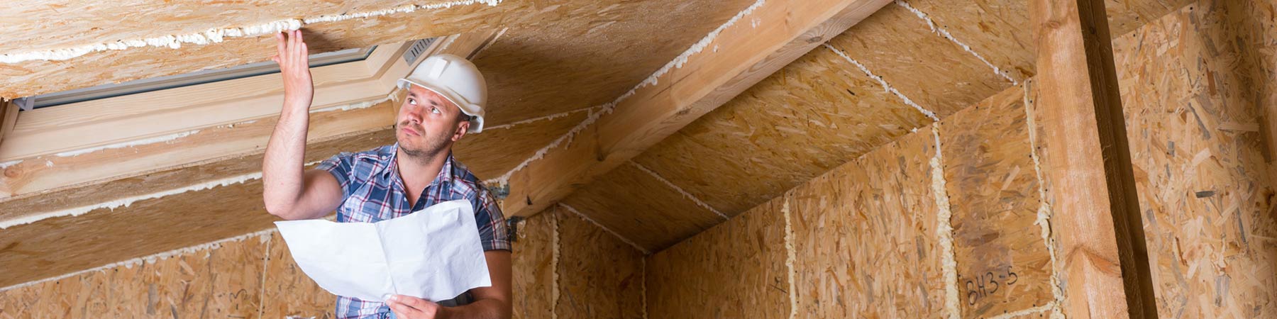 residential home inspector checking attic insulation