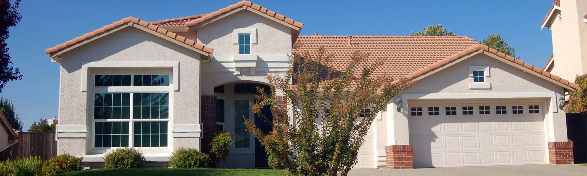 single story home with clay tile roofing